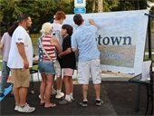 Residents sign the community mural