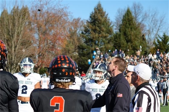 Photo of Mayor Perry tossing the coin at the North vs. South football game