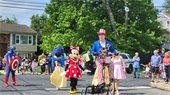 Disney characters and patriotic man on a unicycle
