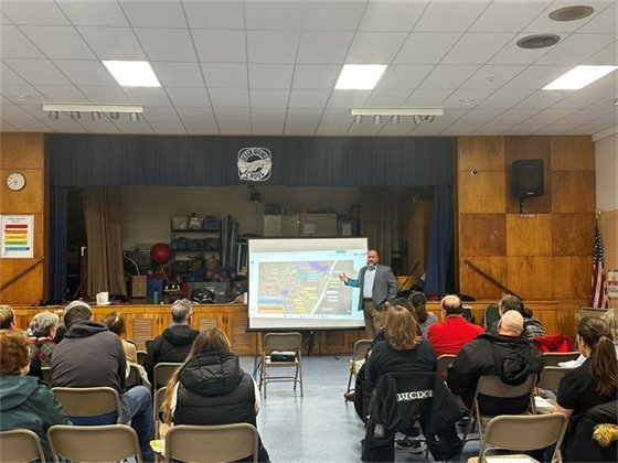 DPW Director Ted Maloney addresses the packed room of involved community members.