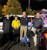 Photo of MTPD Chief R. Craig Weber, Sergeant Michael Heaton, MTPD Explorer, K9, and trick-or-treater