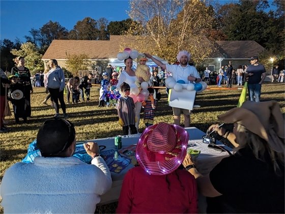 A family shows off their costume to the judges