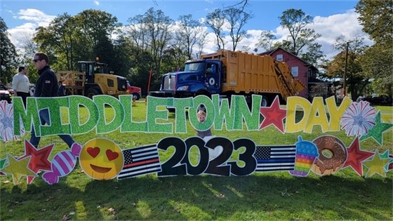 Photo of Mayor Tony Perry's son posing with the Middletown Day sign